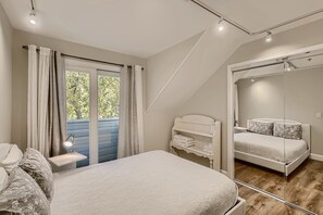 Queen bedroom with large mirrored closet, premium bedding, and blackout curtains