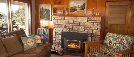 Cozy living room with Knotty pine vaulted ceiling, TV, stereo and wood fireplace