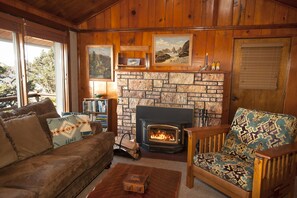 Cozy living room with Knotty pine vaulted ceiling, TV, stereo and wood fireplace