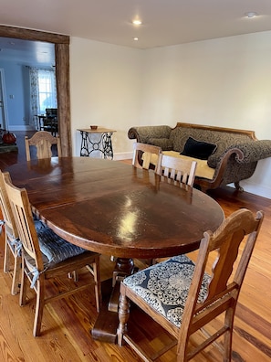 Dining room includes casual seating on sofa.