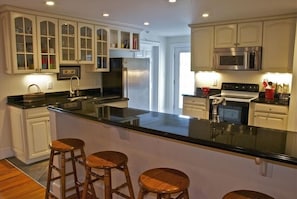 Chef's Kitchen with all the amenities and countertop stools for a casual meal.