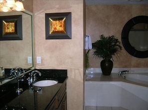 Master bath with twin vanity, large soaking tub and shower.   