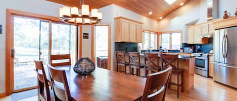 Dining for 10 + 4 stools, doors to deck w/ view of Woodlands course & hot tub