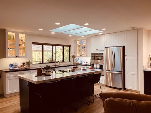 Kitchen open to family room with bar seating