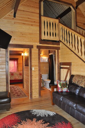 cozy couch with great views and the staircase to loft