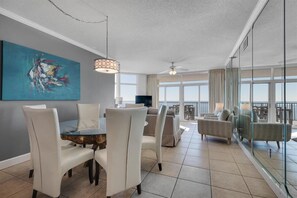 Elegant dining space for 6; room for more at kitchen bar - and on the balcony.