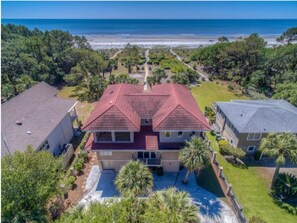 Aerial view of front of home and over the roof to the ocean.
