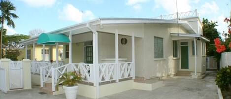 Typical Barbadian stone property, designed with striking hardwood balustrades.