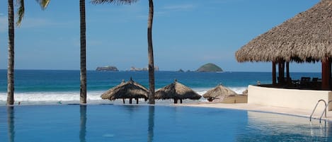 Adult Infinity Pool Overlooking the Private Beach Palapas