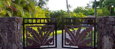 Front gate welcomes you into a private, secure one acre lot