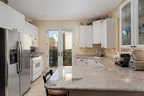 Meticulously equipped kitchen with private washer and dryer.