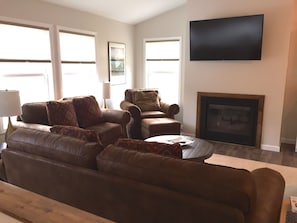 Living room with gas fireplace and smart tv