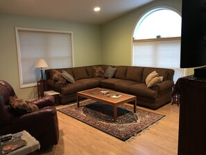 Newly remodeled living room with luxery furniture and 56" wall mount tv.