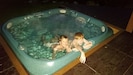 kids playing in the new hot tub on new trex deck with waterfall and lights