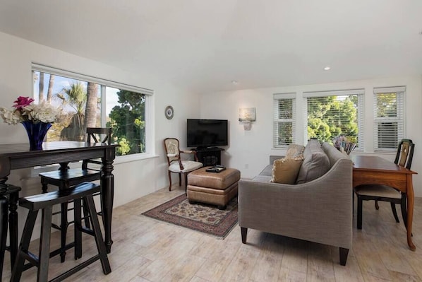 The dreamy, sun-soaked living room, with picturesque skyline & mountain views.