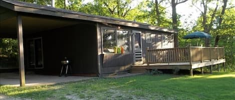 Cabin sets above the river. The river is a the end of the  deck.