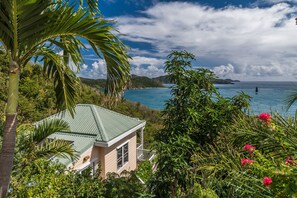 Overlooking Hurricane Hole and surrounded by beautiful gardens.