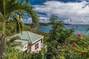 Overlooking Hurricane Hole and surrounded by beautiful gardens.