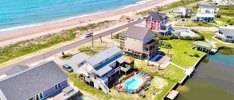 Property on canal, with dock, pool, tiki bar and just across from public  beach