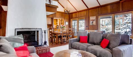 Living room and dining room wrap around the warm and cozy fireplace.