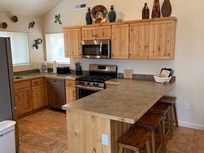 Fully equipped kitchen - place settings, cookware, silverware, baking dishes