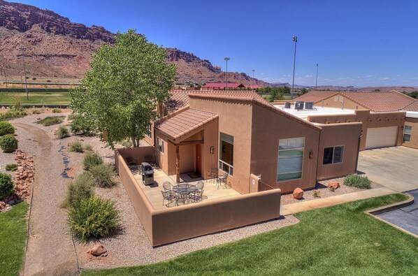 Large patio with Weber gas grill and outdoor furniture