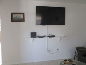 Main Room.  New 58" LED, WIFI rounter, cable box and modem
