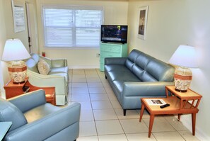 Living room with comfortable Natuzzi leather couch and chair