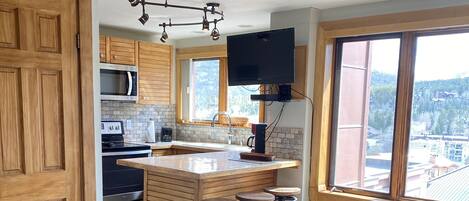 Living area with full kitchen and smart TV