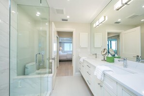Brightly Lit Master Bathroom With Quartz Vanity And Large Walk-In Glass Shower