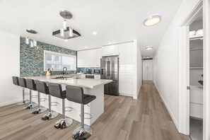 Custom Kitchen with bar stools, undercounter lighting, Wifi lights