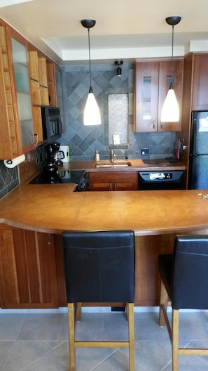 Stained concrete counters and incredible detailed tiled back splash and walls...