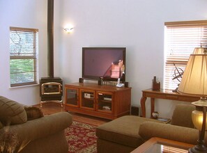 The living room features a spacious vaulted ceiling interior