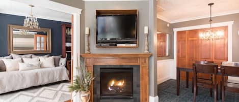 Gas fireplace in living room with dining room to right and library to left.