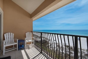 Balcony has four comfortable chairs - enjoy the view of white sand beaches.