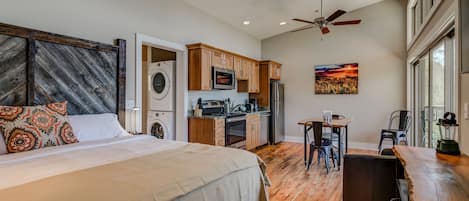 Full kitchen, dining, and king bed in efficient open concept studio space.