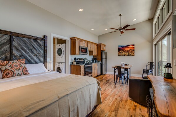 Full kitchen, dining, and king bed in efficient open concept studio space.