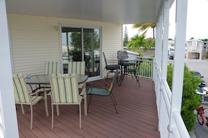 Covered upper deck with tables and chairs for dining or entertaining