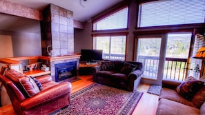 Comfortable living room with amazing views, gas fireplace, and sleeper sofa.

