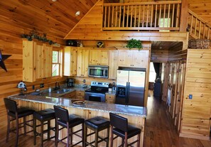 Fully equipped kitchen with eat-in breakfast bar and adjoining large dining area