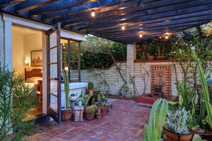 Patio with view of fountain looking into queen bedroom