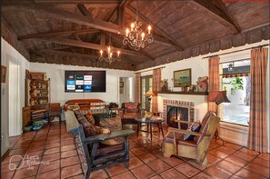 Living room with fireplace.  TV offering free Hulu, Netflix and Amazon Prime.