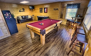Huge game room with pool table, multi-cade and air hockey.  
