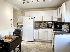 Dining area/kitchen with oven, fridge, microwave, coffee machine, toaster