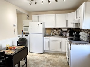 Dining area/kitchen with oven, fridge, microwave, coffee machine, toaster