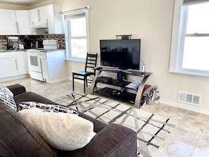 Main area with large sofa and smart TV