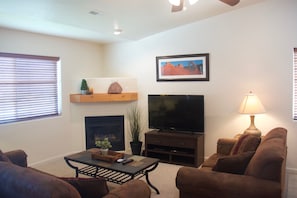 Living room with fireplace and TV