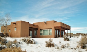 A spacious home, inside & out. Snow covered grounds.