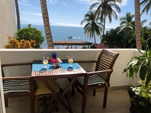 Cute balcony, great view.  Is that a boat out there?