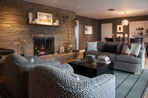 Living room with fireplace and views to the back patio.